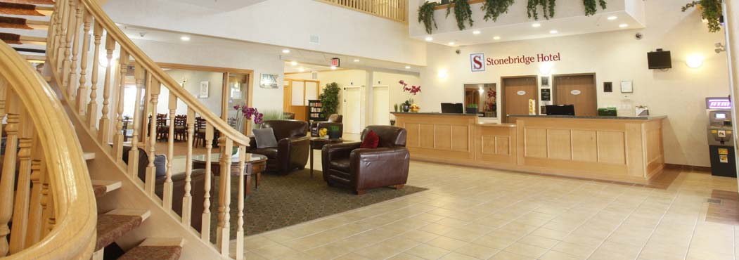 Stonebridge front lobby reception area with wooden staircase in Dawson Creek